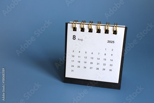 Monthly calendar template for the new year 2025 desk calendar,isolated on Blue background. photo