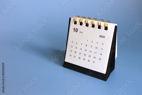 Monthly calendar template for the new year 2025 desk calendar,isolated on Blue background. photo