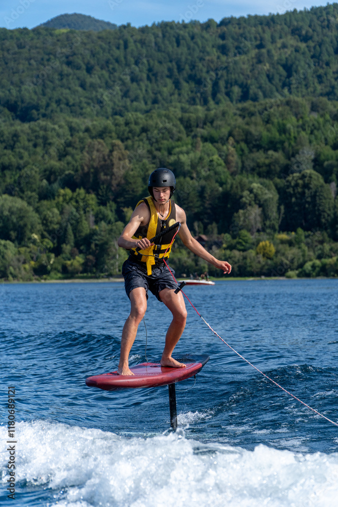 Young Man Practicing Foil Surfing on a Lake