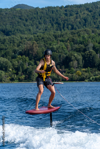 Obraz na płótnie Young Man Practicing Foil Surfing on a Lake w salonie