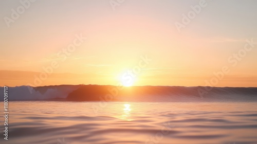 The sun is setting over the ocean, casting a warm glow on the water
