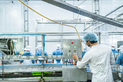 scientist food processing plant supervisor examines industrial control systems, overseeing the production line to maintain high-quality standards and optimize the automated manufacturing process.