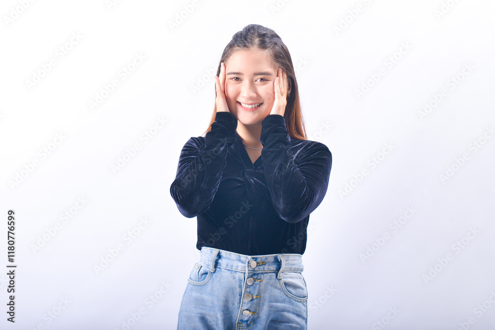 A young Asian Woman in a Black Velvet Top and Denim Jeans making expressive gestures Isolated on white background A young Asian Woman in a Black Velvet Top and Denim Jeans making expressive gestures Isolated on white background