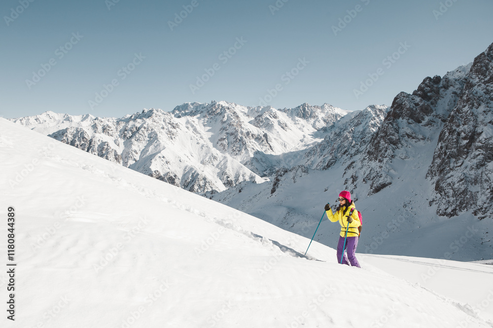 Woman Walking up Mountain in Yellow Jacket Woman Walking up Mountain in Yellow Jacket