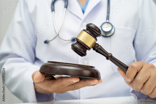 Doctor holding judge gavel, forensic medicine, medical law and crime justice.