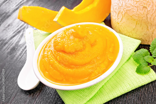 Pumpkin puree in plate on dark board