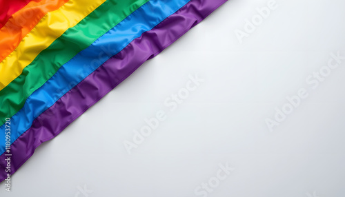 A smooth, folded rainbow-colored fabric laid flat, symbolizing the pride and inclusivity of the LGBTQ+ community, creativity, and the beauty of diversity in society. photo