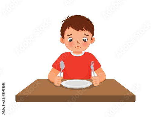 Sad little boy feel hungry looking at empty plate