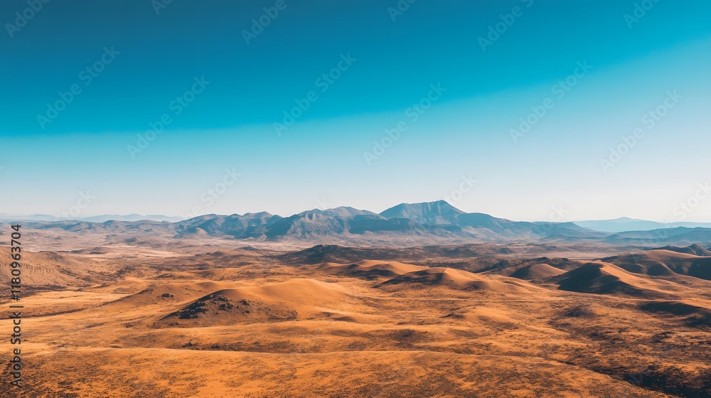 Naklejka premium Aerial view of golden sand dunes in a vast desert landscape under a clear blue sky, showcasing natural serenity.