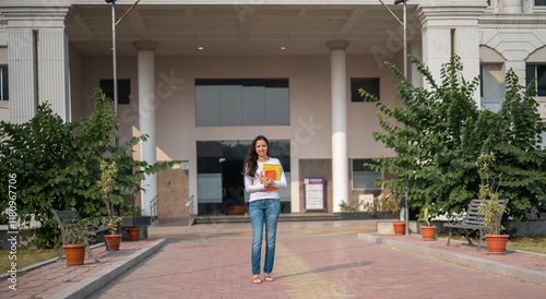 University student, indian woman and portrait at campus outdoor with books of learning, education or knowledge, scholarship and motivation. 