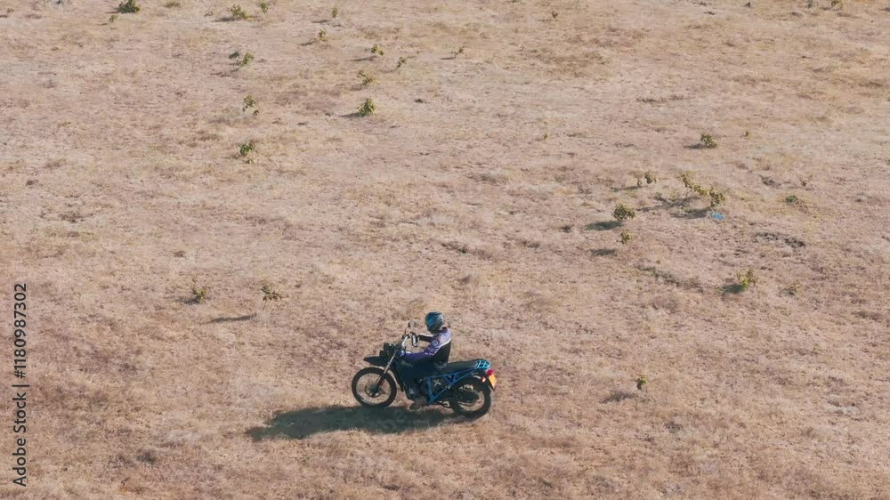 Man riding off-road bike in African beautiful landscape Man riding off-road bike in African beautiful landscape