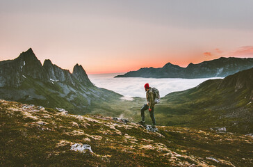 Man backpacker hiking in mountains alone  outdoor active lifestyle travel adventure vacations sunset Norway landscape