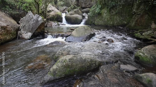 Shallow Sabie River drops elevation in riffles through stone boulders photo