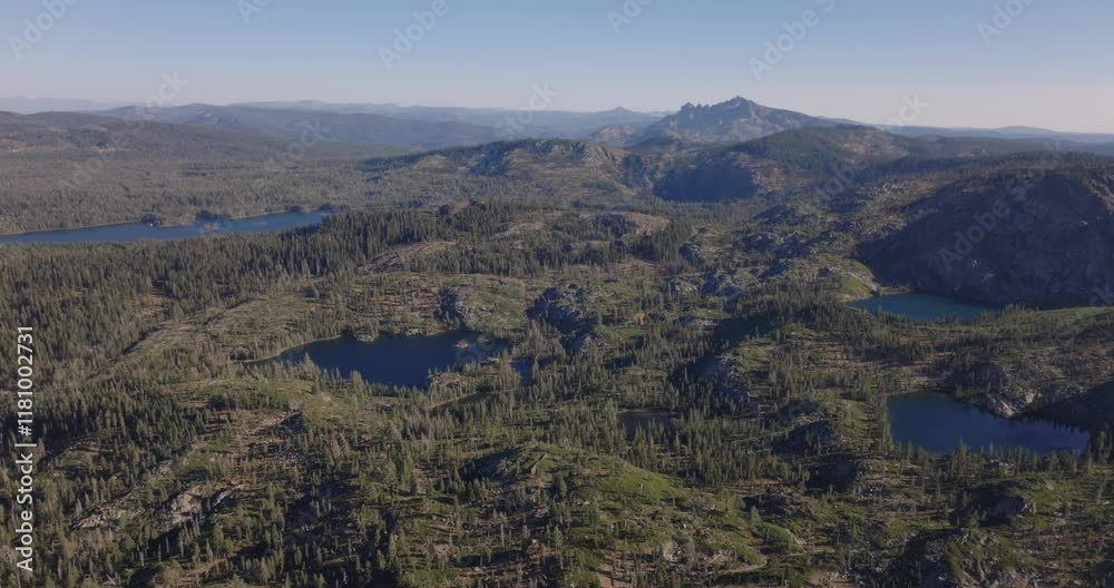 Serene mountain lakes surrounded by forest in lakes basin on a sunny day, aerial view Serene mountain lakes surrounded by forest in lakes basin on a sunny day, aerial view