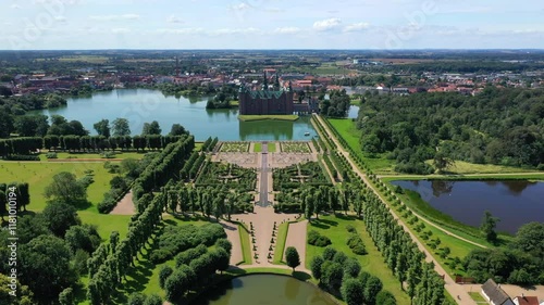 Flying Over The Lake And Baroque Garden To The Frederiksborg Castle In Hillerod, Denmark. - aerial shot photo