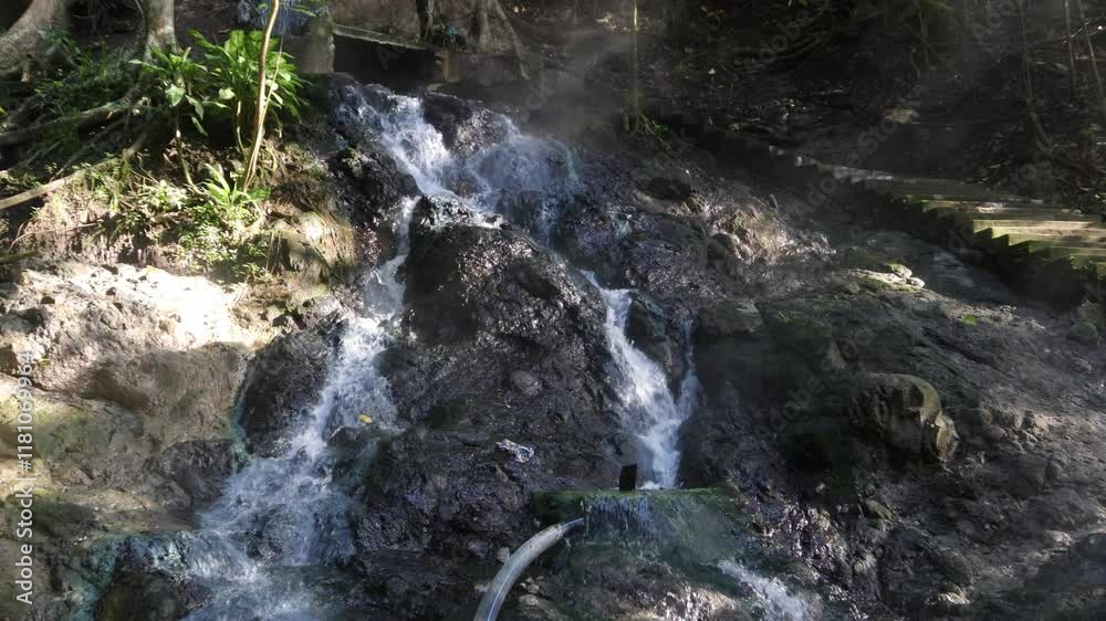 Hot water river flow in forest tourism in the mountainous area of Sulawesi, Indonesia Hot water river flow in forest tourism in the mountainous area of Sulawesi, Indonesia