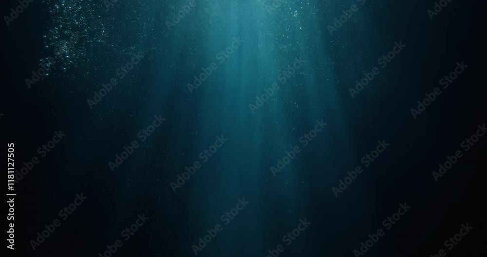4K slow-motion footage of underwater god rays piercing the ocean surface, with enchanting beams of light flickering. Ideal VFX background for diving, snorkeling, and summer adventures.