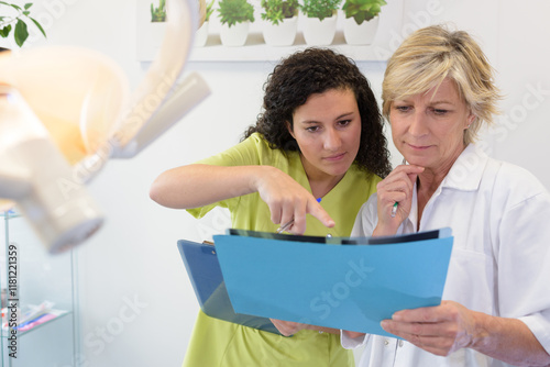 portrait of medical radiology assistant talking with manager
