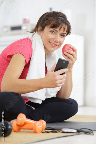 woman girl sitting lifestyle using smartphone after training exercise workout photo