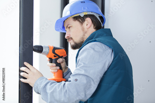 a man drills a frame window