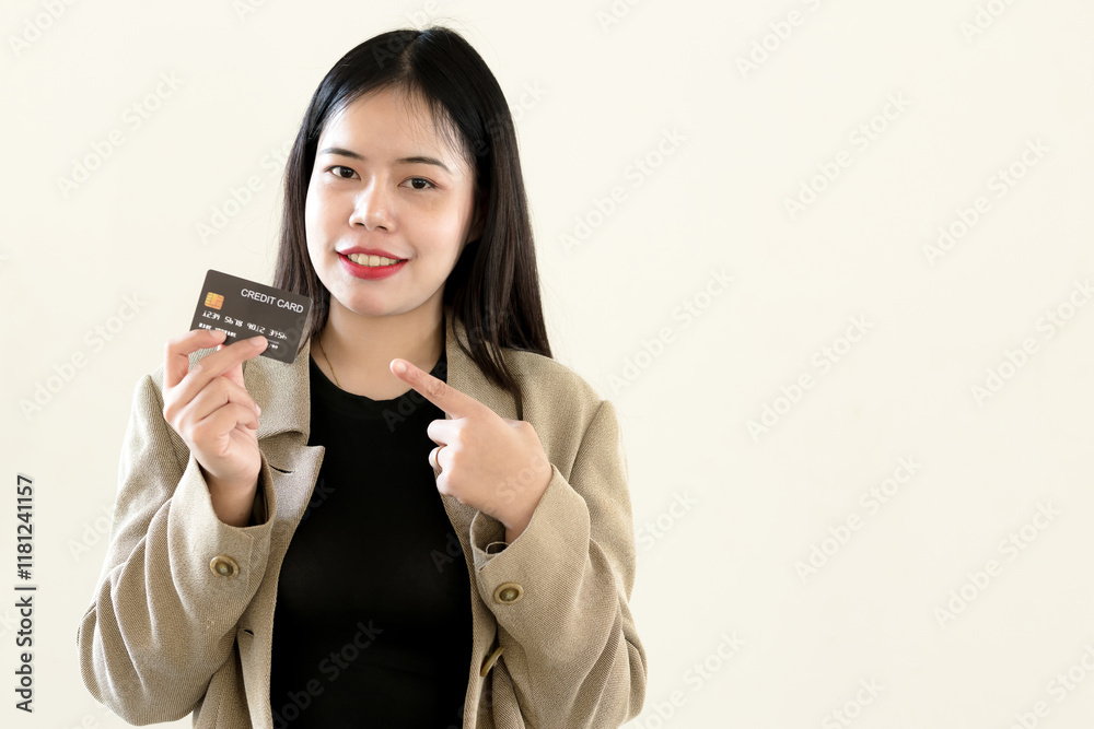 Businesswoman smiling and holding credit card on light yellow isolated background Businesswoman smiling and holding credit card on light yellow isolated background