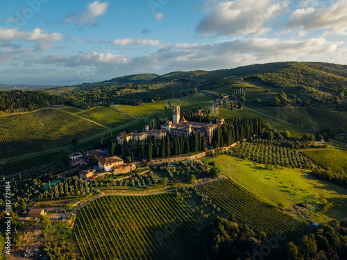 Aerial view of the historic Abbey of San Michele Arcangelo a Passignano surrounded by lush vineyards and rolling hills, Barberino Tavarnelle, Italy. photo