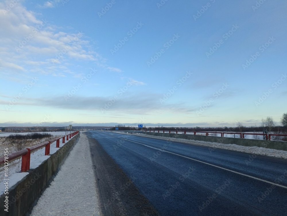 Two way road in countryside. Two lane street. Trees and bushes growing around. Snow is laying on ground. Countryside. Two way road in countryside. Two lane street. Trees and bushes growing around. Snow is laying on ground. Countryside.