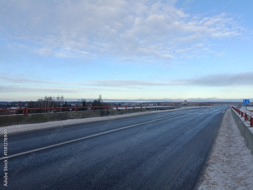 Two way road in countryside. Two lane street. Trees and bushes growing around. Snow is laying on ground. Countryside. Two way road in countryside. Two lane street. Trees and bushes growing around. Snow is laying on ground. Countryside.