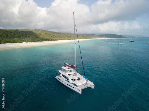 Aerial view of beautiful sailboats on the azure ocean near the tropical coastline, Whitsundays, Australia. photo