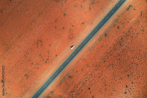 Aerial view of vast arid desert landscape with a lonely campervan on the Great Northern Highway, Port Hedland, Australia. photo