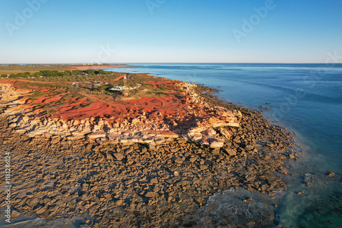 Aerial view of rugged coastline with red rocks and dinosaur footprints, Gantheaume Point, Western Australia. photo