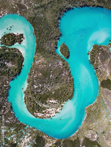 Aerial view of meandering turquoise river surrounded by lush greenery and pristine wilderness, Willies Creek, Kimberley Region, Australia.