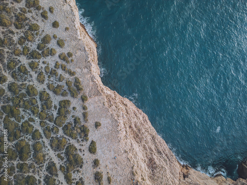 Aerial view of Cabo de Sao Vicente with rugged cliffs and green bushes overlooking the ocean, Sagres, Portugal. photo