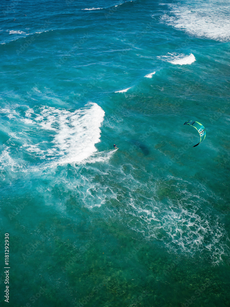 Aerial view of kite surfers riding the waves in a beautiful tropical ocean, Sosua, Dominican Republic. Aerial view of kite surfers riding the waves in a beautiful tropical ocean, Sosua, Dominican Republic.