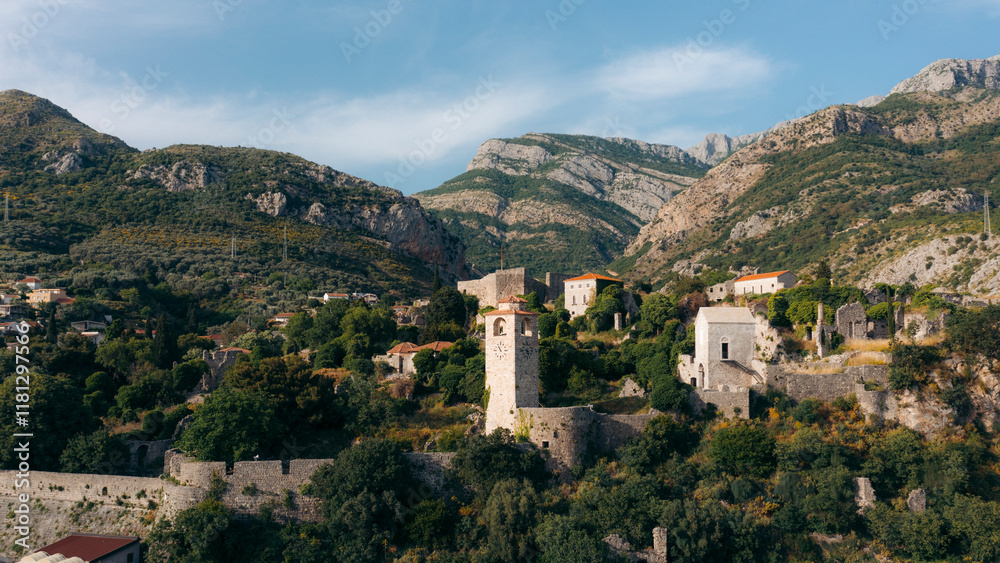 Aerial view of old town with medieval stone buildings and a tower surrounded by mountains and greenery, Stari Bar, Montenegro. Aerial view of old town with medieval stone buildings and a tower surrounded by mountains and greenery, Stari Bar, Montenegro.