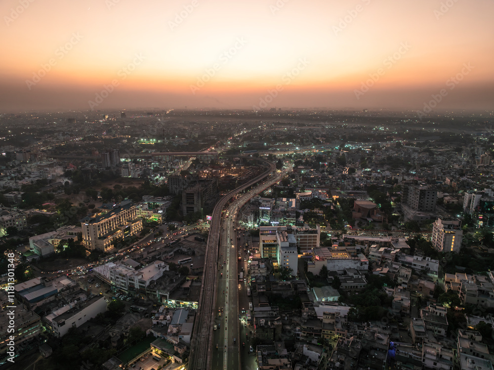 Aerial view of a crowded urban landscape at sunset with city lights and modern buildings, Sindhi Camp, Jaipur, India. Aerial view of a crowded urban landscape at sunset with city lights and modern buildings, Sindhi Camp, Jaipur, India.