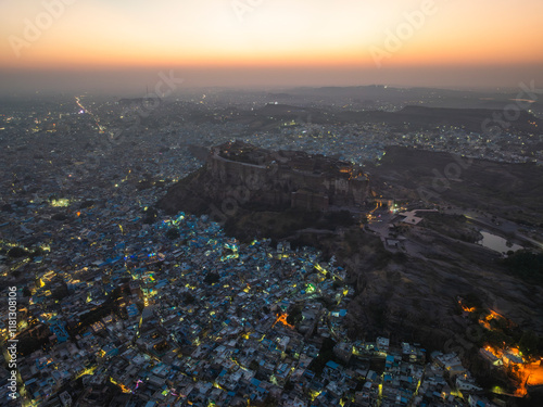 Aerial view of mehrangarh fort and cityscape at dusk with city lights, Jodhpur, India. photo