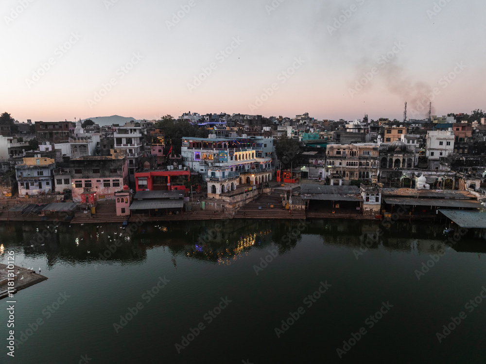 Aerial view of Pushkar Lake with beautiful ghats and historic architecture at sunset, Pushkar, Rajasthan, India.