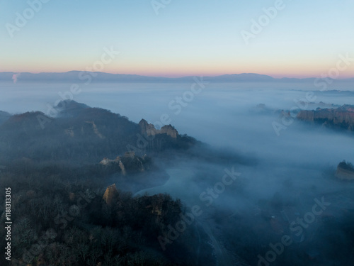 Aerial view of balze valdarno landscape shrouded in fog and mist at sunrise, Tuscany, Reggello, Italy. photo