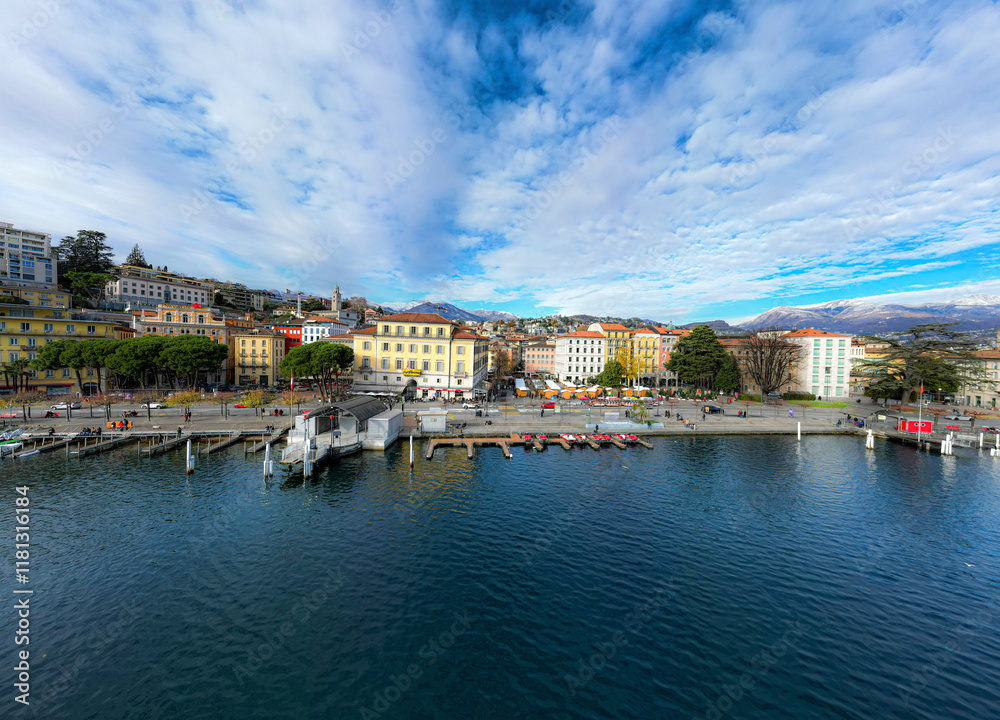 Aerial view of beautiful harbor promenade with serene water and picturesque buildings, Lugano, Switzerland. Aerial view of beautiful harbor promenade with serene water and picturesque buildings, Lugano, Switzerland.