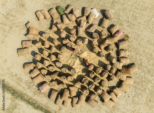 Aerial view of a rural landscape with bags and sacks arranged in a circular pattern in a field, Kastail, Bangladesh. photo