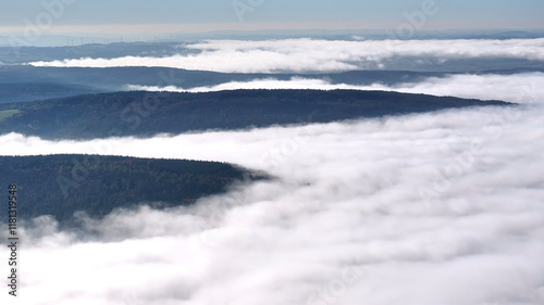 Aerial view of tranquil misty forest and hills under cloudy sky, Eichenzell, Germany. photo