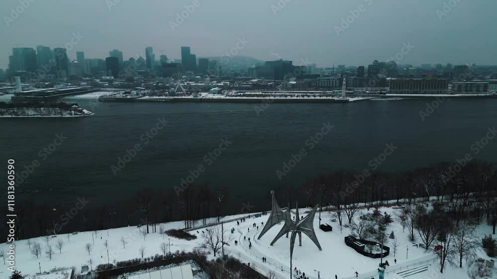 aerial shot over Jean drapeau Park in Montreal city with the saint laurent river and the city skyline in the background on a moody winter day, Quebec Region, Canada