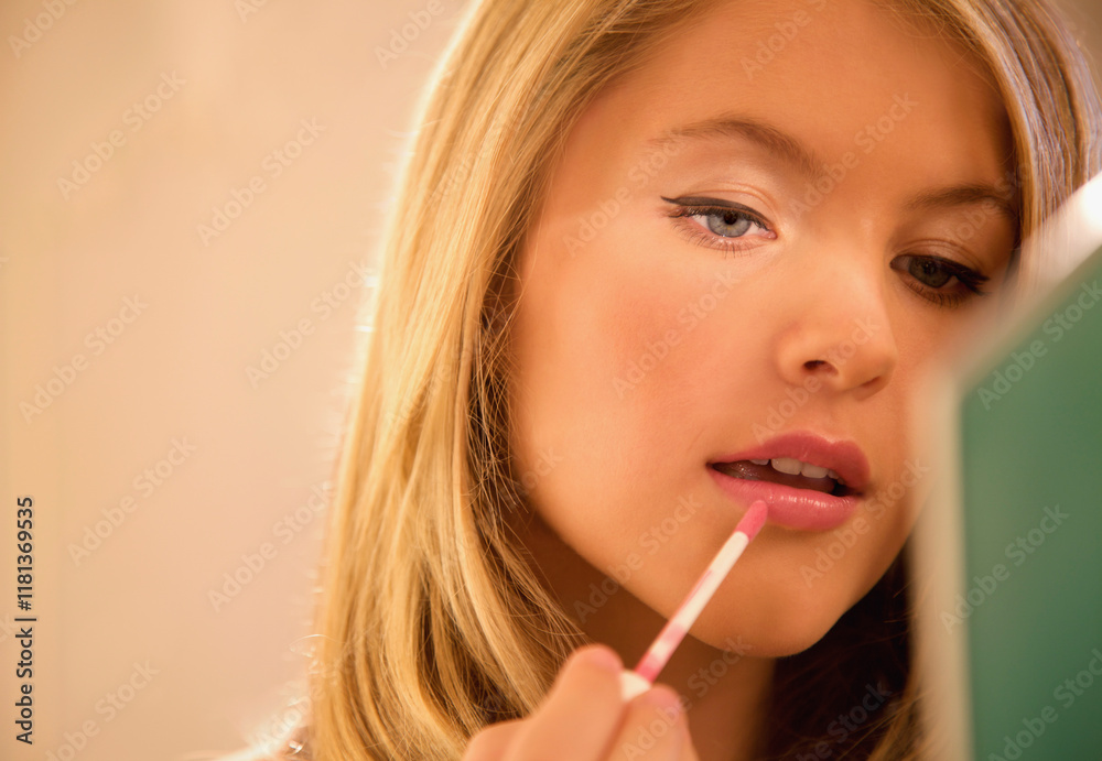 Close up of a young woman applying lip gloss
Close up of a young woman applying lip gloss
