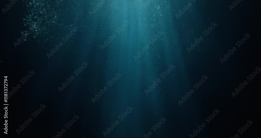 Stunning 4K slow-motion footage of underwater god rays piercing the ocean surface, with enchanting beams of light flickering. Ideal VFX background for diving, snorkeling, and summer adventures.