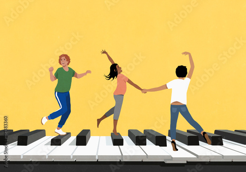 Happy young friends dancing on large piano against yellow background
