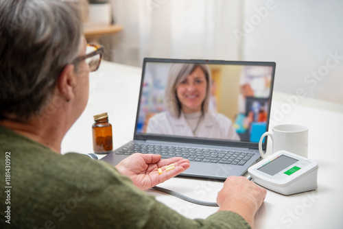 Senior woman using laptop for online medical consultation with doctor at home