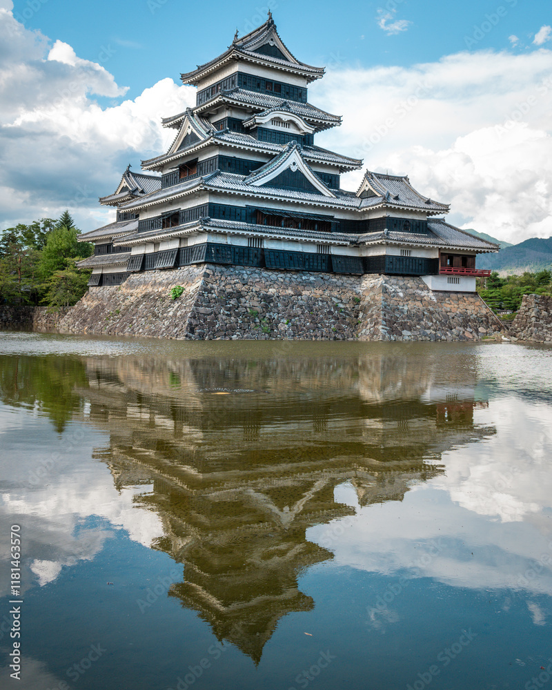 Matsumoto Castle and its reflection in the lake Matsumoto Castle and its reflection in the lake