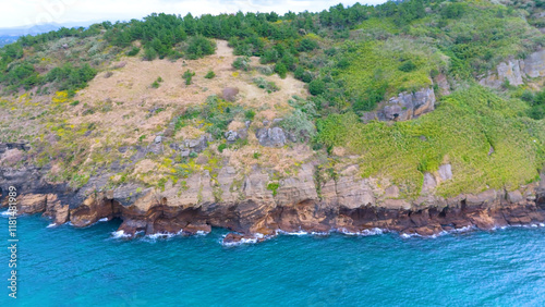 The beautiful island, Chagwido Island, and Wawa of Jeju Island in Korea are taken with drones from the sky, the sea, waves, and beautiful nature photo
