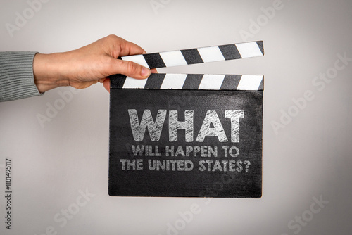 What will happen to the United States. Female hands holding movie clapper. photo